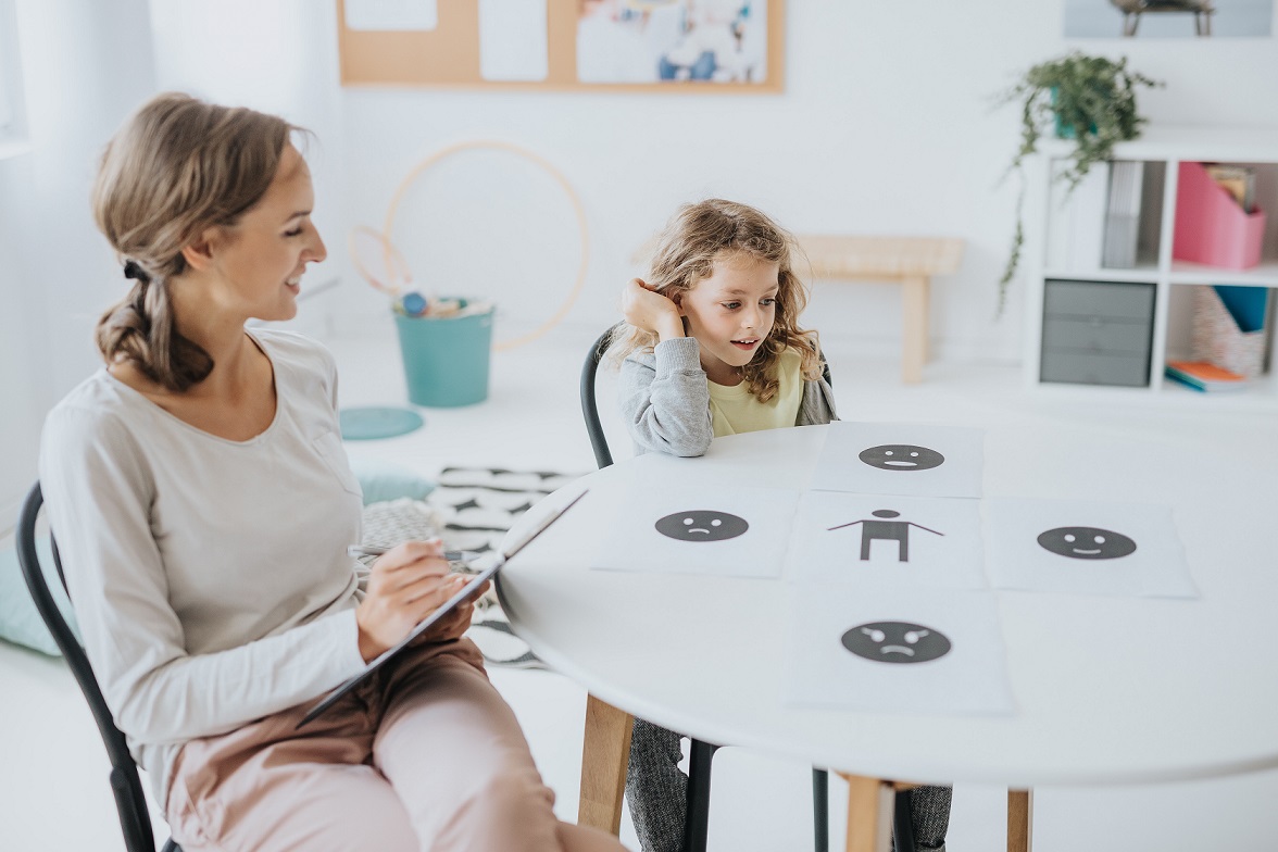 School psychotherapist Young school psychotherapist helping the boy express emotions